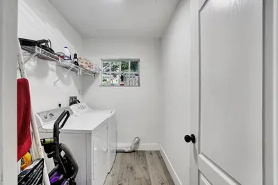 a white laundry room with a washer and dryer at 8BR-4BA Spacious House, Sleeps 20, Pool, Fenced Yd in Miami