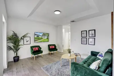a living room with a green couch and two chairs at 8BR-4BA Spacious House, Sleeps 20, Pool, Fenced Yd in Miami