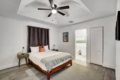 a bedroom with a bed and a ceiling fan at 8BR-4BA Spacious House, Sleeps 20, Pool, Fenced Yd in Miami