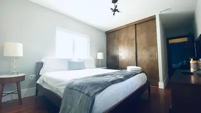 a bedroom with a large bed and a window at Experience Miami Magic: Tropical Pool Escape in Miami