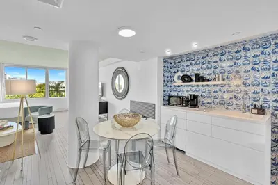 a kitchen and dining room with a table and chairs at 1100 West South Beach Lux Waterfront Studio in Miami Beach