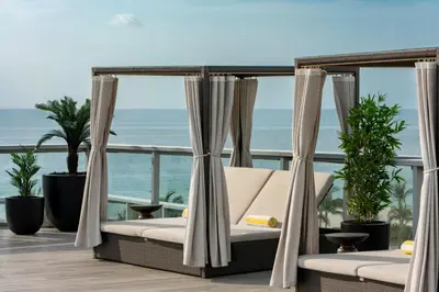 a swing on a balcony with a view of the ocean at AC Hotel by Marriott Miami Beach in Miami Beach