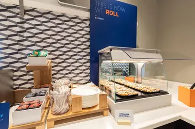 a display case with donuts and other pastries at Holiday Inn Express & Suites Miami Airport East by IHG in Miami