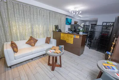 a living room with a white couch and a table at Seaside All Suites Hotel in Miami Beach