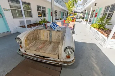 an old car parked outside of a building at Seaside All Suites Hotel in Miami Beach