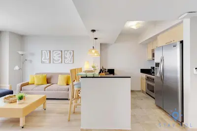 a kitchen and living room with a couch and a table at 1BR Apartment with beautiful view in Sunny Isles Beach