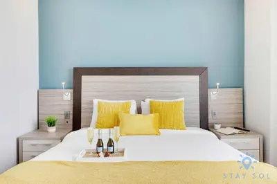 a bedroom with a large white bed with yellow pillows at 1BR Apartment with beautiful view in Sunny Isles Beach