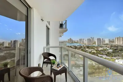a balcony with chairs and a view of the city at 1BR Apartment with beautiful view in Sunny Isles Beach
