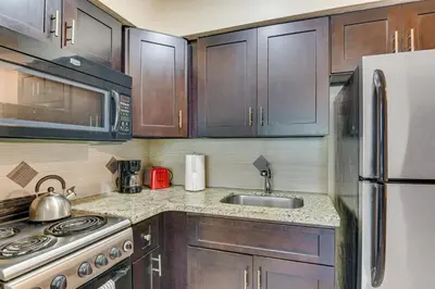a kitchen with a stove and a sink and a refrigerator at Centrally Located Hallandale Beach Condo in Hallandale Beach