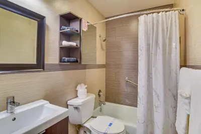 a bathroom with a toilet and a sink and a shower at Centrally Located Hallandale Beach Condo in Hallandale Beach