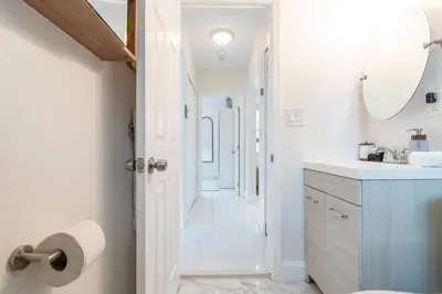 a bathroom with a sink and a mirror at ArtHaus- Fully Stocked Kitchen and Fenced Yard in Miami