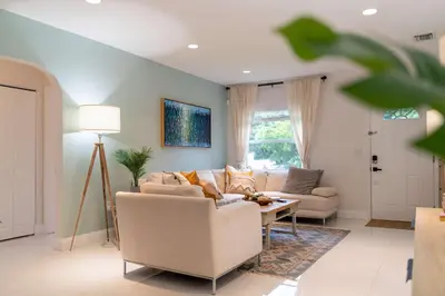 a living room with a couch and a table at ArtHaus- Fully Stocked Kitchen and Fenced Yard in Miami