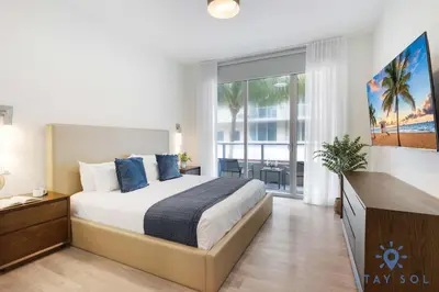 a bedroom with a large bed and a large window at 2BR Apartment with Rooftop Pool in Hollywood