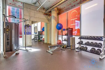 a gym with a bunch of equipment in a room at 2BR Apartment with Rooftop Pool in Hollywood
