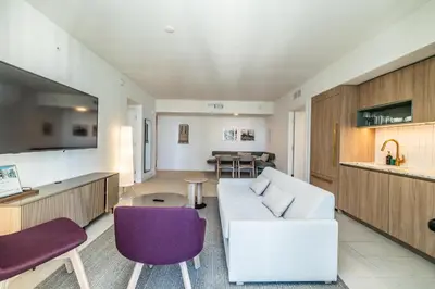 a living room with a white couch and purple chairs at Stunning 2 Bed 2 Bath w balcony & incredible views in Miami