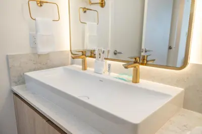 a bathroom with a white sink and a mirror at Stunning 2 Bed 2 Bath w balcony & incredible views in Miami
