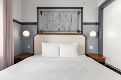 a bedroom with a large white bed with two pillows at The Daydrift in Miami Beach