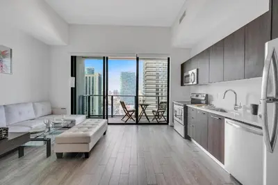 a kitchen and living room with a view of a city at Luxury Downtown Miami Apartment in Miami