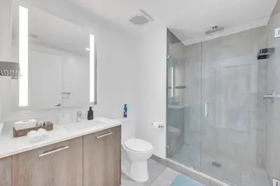 a bathroom with a shower and a toilet and a sink at Luxury Downtown Miami Apartment in Miami