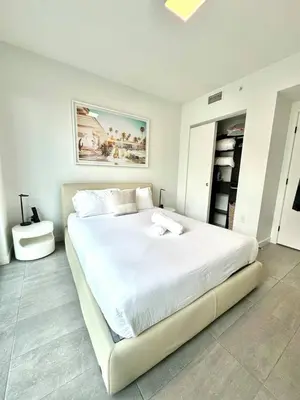 a white bedroom with a large white bed in it at 2 bedrooms Design Condo Downtown Miami Pool and Gym in Miami