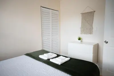 a bedroom with a bed with two towels on it at Central Getaway in Little Havana Near Airport, Wynwood, Calle 8 Brickell, Coral Gables and more , Fenced parking in Miami