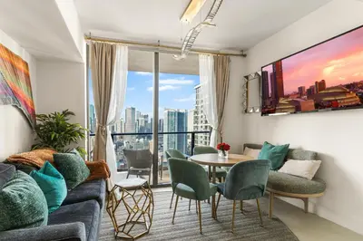 a living room with a couch and a table and chairs at Miami Luxury 27th Floor, Best Waterfront Balcony View & City Lights, Pool,Gym,Spa in Miami