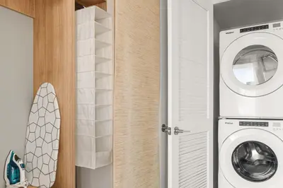 a laundry room with a washer and a washing machine at Miami Luxury 27th Floor, Best Waterfront Balcony View & City Lights, Pool,Gym,Spa in Miami