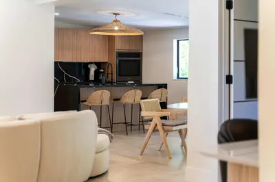 a kitchen and living room with a table and chairs at Casa Siesta- Hot tub Home Gym and Modern Design in Miami