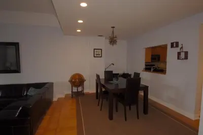 a living room with a table and a couch at Luxury Ocean Front Condo on Millionaires Row in Miami Beach