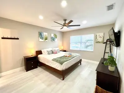 a bedroom with a bed and a ceiling fan at 1 Block from the Beach 2BR 2BA Newly Renovated in Fort Lauderdale