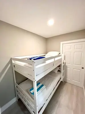 a white bunk bed in a room with a door at 1 Block from the Beach 2BR 2BA Newly Renovated in Fort Lauderdale