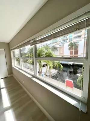 an empty room with a large window with palm trees at 1 Block from the Beach 2BR 2BA Newly Renovated in Fort Lauderdale
