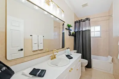 a bathroom with a sink and a large mirror at Daiquiri in Dania Beach