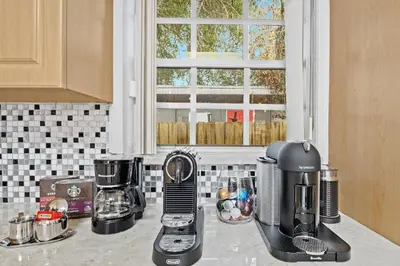 a kitchen counter with several appliances on a counter top at Daiquiri in Dania Beach