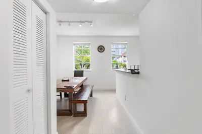 a dining room with a wooden table and a dining room table at Bayside Townhome - Private Beach Access, Pool and Hot Tub, Free Parking in Golden Isles