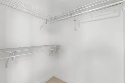 a room with white walls and white shelves at Bayside Townhome - Private Beach Access, Pool and Hot Tub, Free Parking in Golden Isles