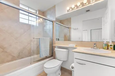 a bathroom with a toilet and a sink and a shower at Bayside Townhome - Private Beach Access, Pool and Hot Tub, Free Parking in Golden Isles