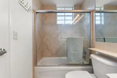a bathroom with a shower with a toilet and a sink at Bayside Townhome - Private Beach Access, Pool and Hot Tub, Free Parking in Golden Isles