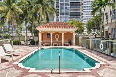 a swimming pool with a gazebo in a courtyard at Bayside Townhome - Private Beach Access, Pool and Hot Tub, Free Parking in Golden Isles
