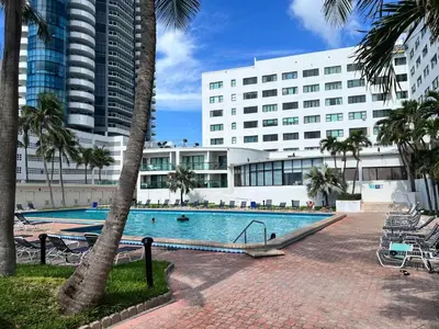 a swimming pool in front of a large building at Casablanca miami beach in Miami Beach