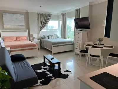 a bedroom with two beds and a living room at Casablanca miami beach in Miami Beach