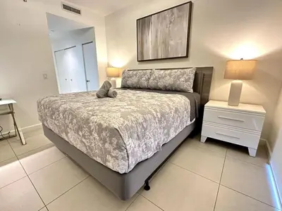 a bedroom with a large bed and a night stand at Doral Studio with Fabulous View in Miami
