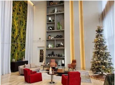a living room with a christmas tree and red chairs at Doral Studio with Fabulous View in Miami