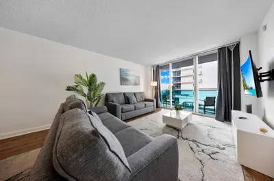 a living room with a couch and a large window at Oceanfront Luxury Condo with Stunning Views and Resort Amenities in Hollywood