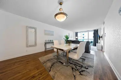 a dining room and living room with a table and a couch at Oceanfront Luxury Condo with Stunning Views and Resort Amenities in Hollywood