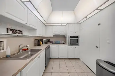 a kitchen with white cabinets and a sink at Oceanfront Luxury Condo with Stunning Views and Resort Amenities in Hollywood