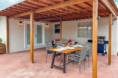 a patio with a wooden table and chairs at Imagine Residence in Hallandale Beach
