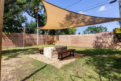 a picnic table and a bench in a yard at Beach Oasis King Bed & Near Hollywood beach in Hollywood