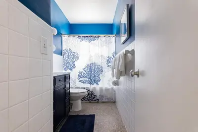 a bathroom with a toilet and a shower curtain at Beach Oasis King Bed & Near Hollywood beach in Hollywood