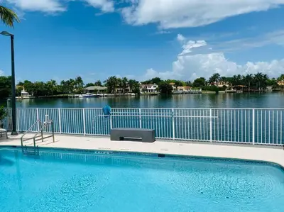 a swimming pool with a view of the water at OCEAN VIEW 1BR 2BA BEACH CONDO Parking in Miami Beach
